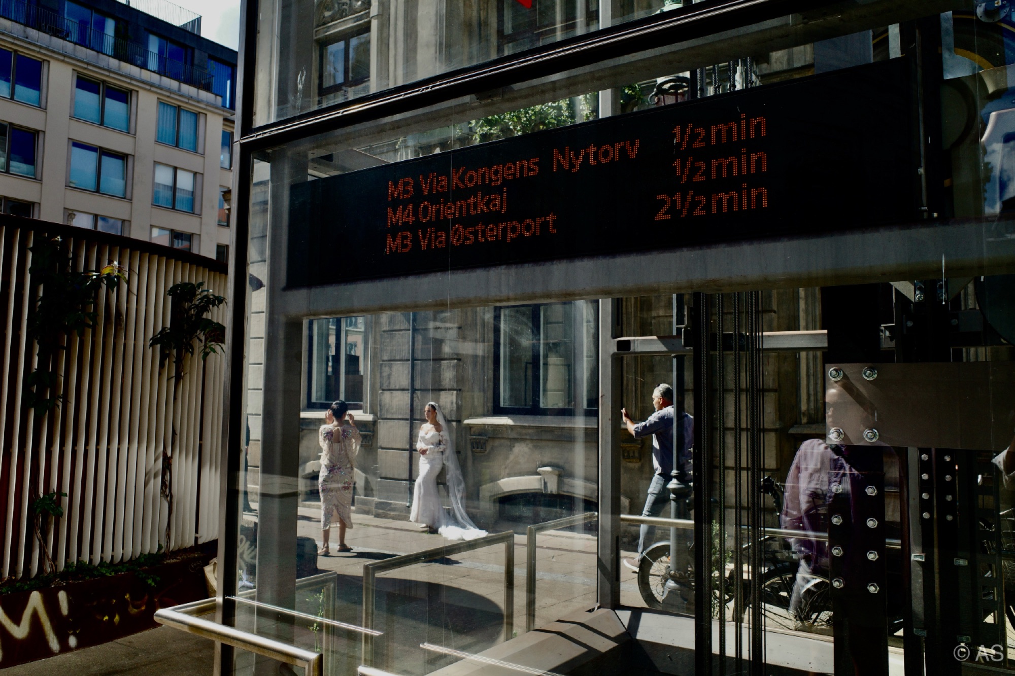 Copenhagen metro station departure board through glass